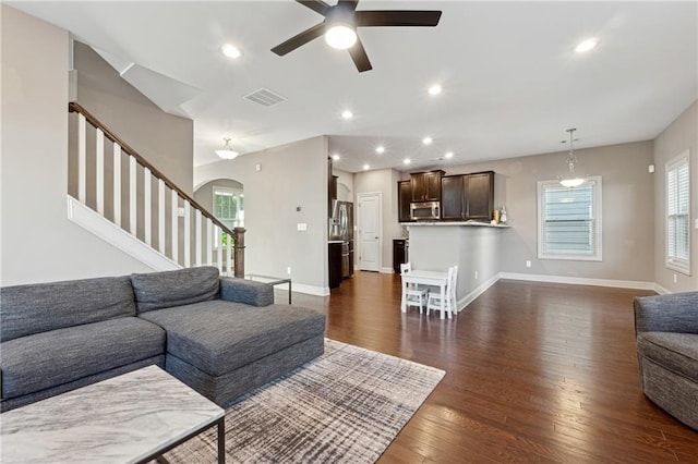 living room with ceiling fan and dark hardwood / wood-style floors