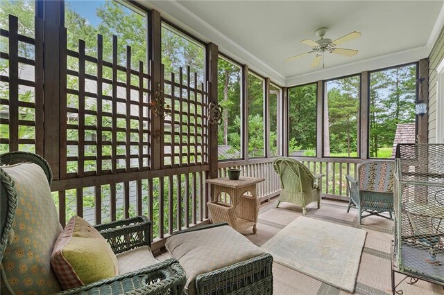 sunroom / solarium featuring ceiling fan and plenty of natural light