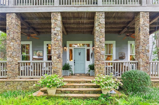 entrance to property featuring a porch and ceiling fan