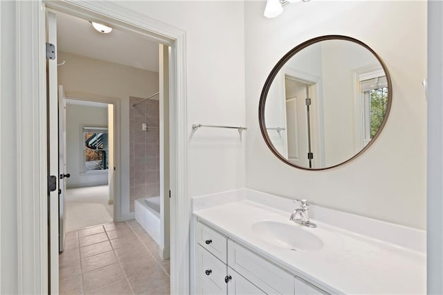 bathroom with vanity, tiled shower / bath combo, and tile patterned floors