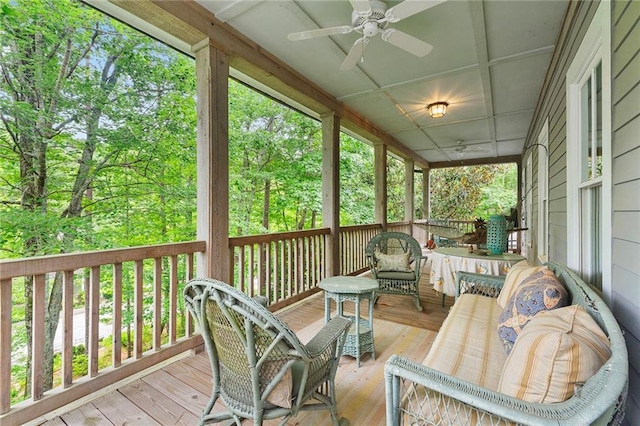 sunroom / solarium with coffered ceiling and ceiling fan