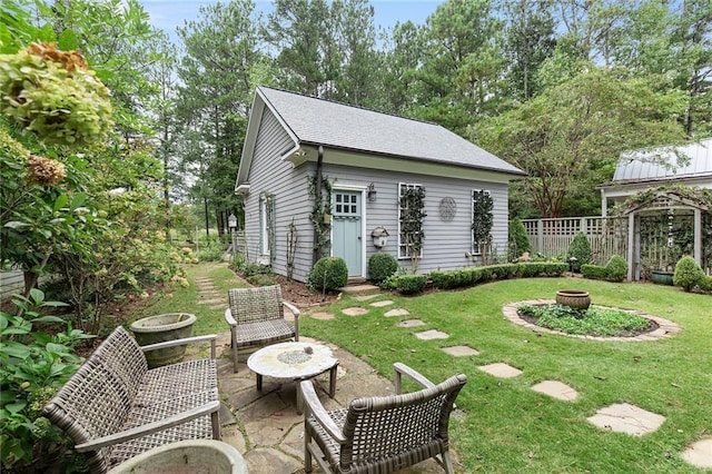 exterior space featuring a patio, an outdoor fire pit, and an outdoor structure