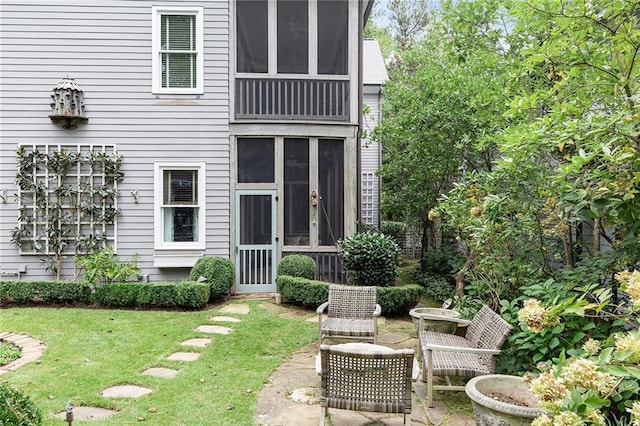 back of property featuring a yard and a patio