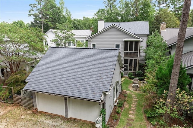 rear view of house with an outdoor fire pit