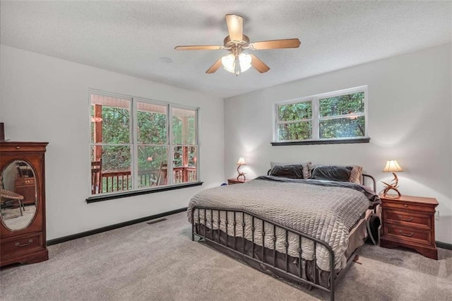 bedroom featuring carpet flooring, a textured ceiling, and visible vents