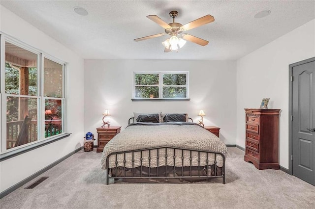 bedroom featuring baseboards, carpet floors, and visible vents