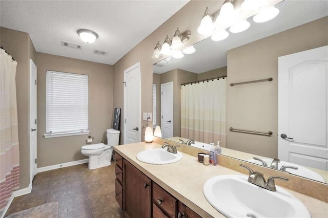 full bathroom with toilet, a sink, baseboards, and visible vents