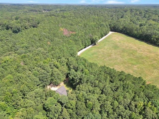 bird's eye view with a wooded view