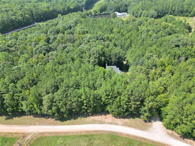 bird's eye view featuring a wooded view