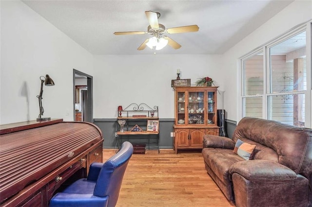 living area with ceiling fan and light wood-style flooring