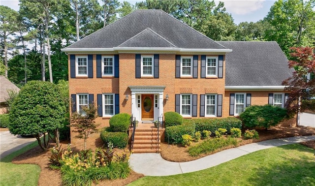 5004 Haralson Way SW, Lilburn, GA 30047 - colonial home featuring brick siding, a shingled roof, and a front yard
