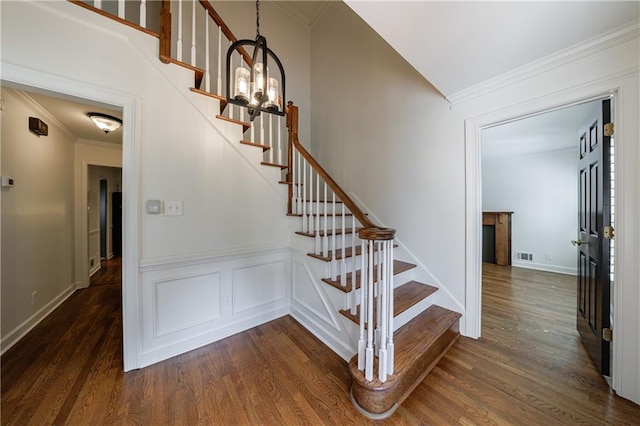 5004 Haralson Way SW, Lilburn, GA 30047 - stairs with wood finished floors, ornamental molding, and lofted ceiling