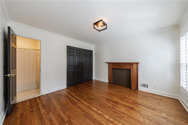 5004 Haralson Way SW, Lilburn, GA 30047 - unfurnished living room featuring ornamental molding and wood finished floors