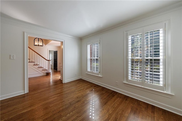 5004 Haralson Way SW, Lilburn, GA 30047 - spare room featuring dark wood finished floors, healthy amount of natural light, stairway, ornamental molding, and a chandelier