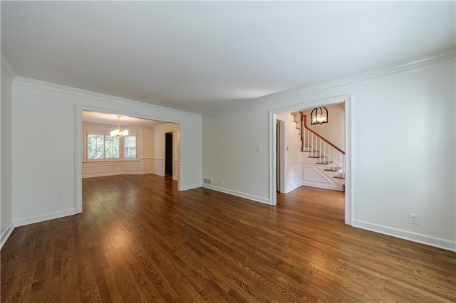 5004 Haralson Way SW, Lilburn, GA 30047 - spare room with a chandelier, stairs, crown molding, and dark wood-style floors
