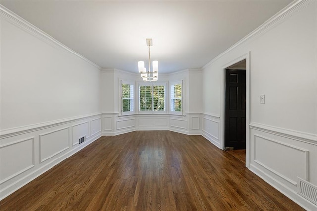5004 Haralson Way SW, Lilburn, GA 30047 - unfurnished dining area featuring a chandelier, a decorative wall, wainscoting, dark wood-type flooring, and crown molding