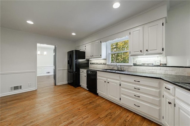 5004 Haralson Way SW, Lilburn, GA 30047 - kitchen featuring black appliances, backsplash, white cabinets, ornamental molding, and light wood-style floors
