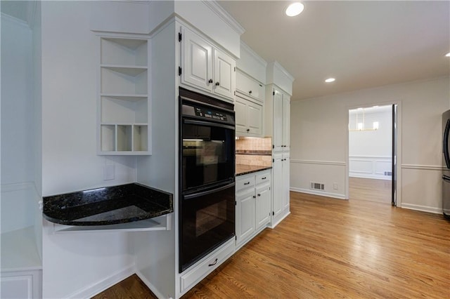 5004 Haralson Way SW, Lilburn, GA 30047 - kitchen featuring white cabinets, decorative backsplash, recessed lighting, dark stone countertops, and light wood finished floors
