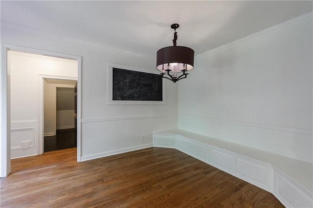 5004 Haralson Way SW, Lilburn, GA 30047 - unfurnished dining area featuring a chandelier, wood finished floors, and crown molding