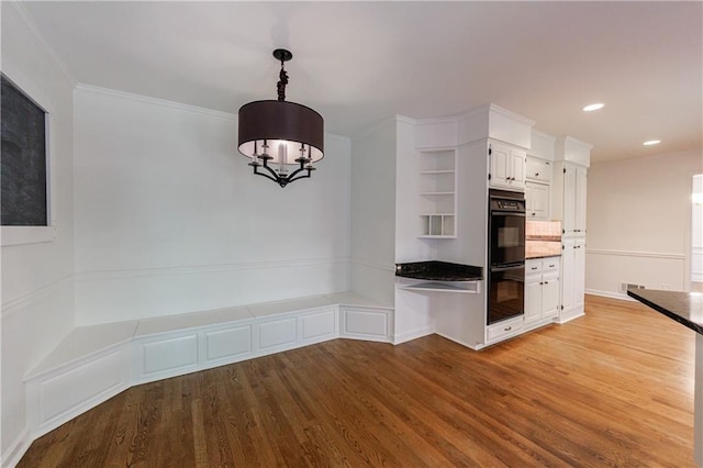 5004 Haralson Way SW, Lilburn, GA 30047 - kitchen featuring open shelves, wood finished floors, white cabinetry, dark countertops, and a chandelier