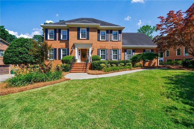 5004 Haralson Way SW, Lilburn, GA 30047 - colonial home featuring a front yard and brick siding