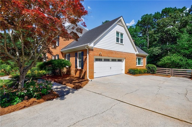 5004 Haralson Way SW, Lilburn, GA 30047 - view of front of property with a garage, brick siding, and driveway