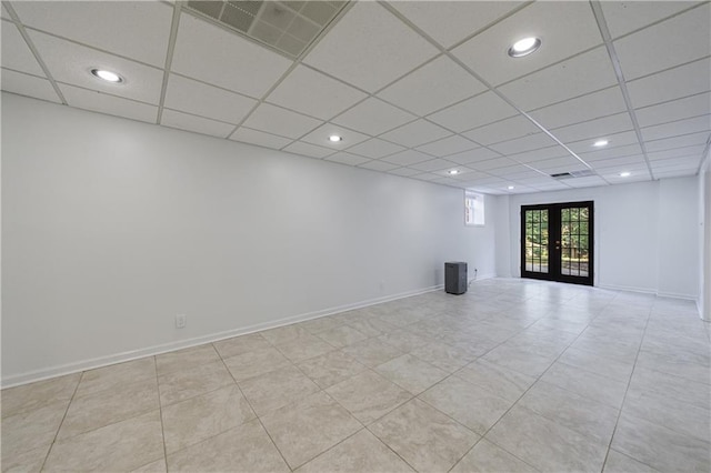 5004 Haralson Way SW, Lilburn, GA 30047 - below grade area with french doors, a paneled ceiling, recessed lighting, and light tile patterned floors