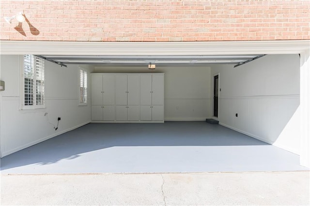 5004 Haralson Way SW, Lilburn, GA 30047 - garage featuring a garage door opener and baseboards