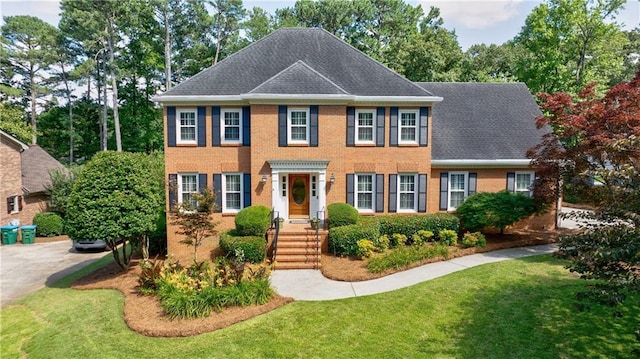 5004 Haralson Way SW, Lilburn, GA 30047 - colonial inspired home with a front lawn, brick siding, and roof with shingles