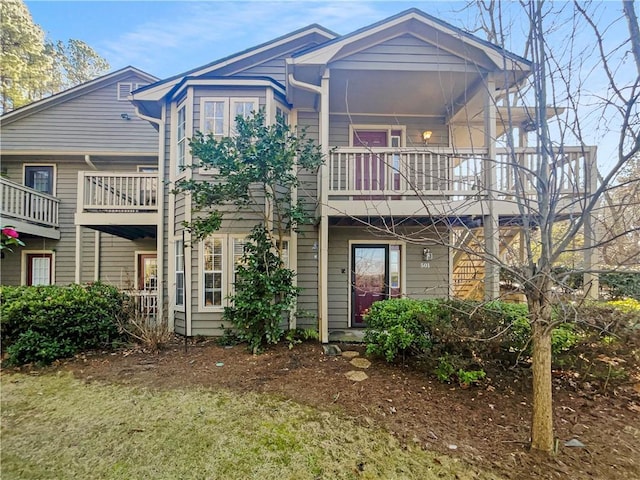 back of property with a balcony