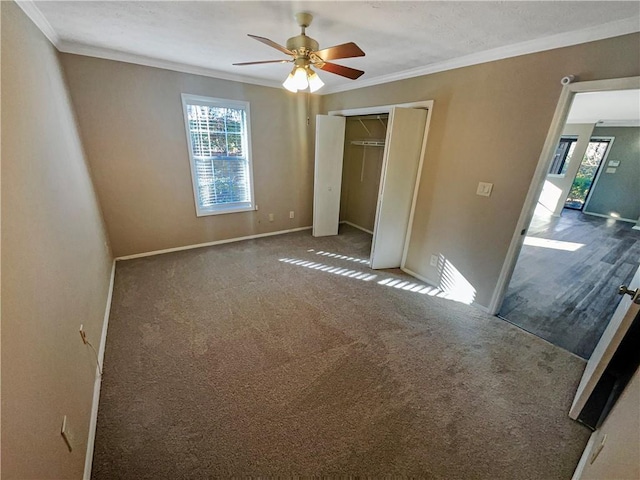 unfurnished living room featuring crown molding and dark wood-type flooring