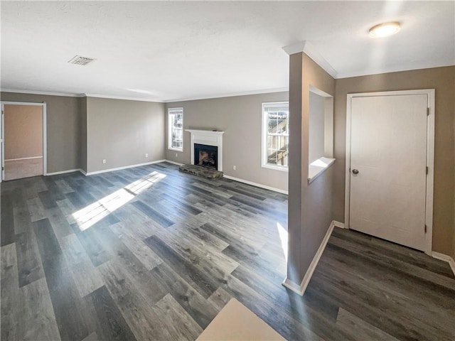 empty room with ceiling fan, crown molding, and dark wood-type flooring