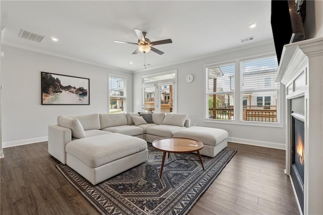 3440 Hardy St, Duluth, GA 30096 - living area with crown molding, ceiling fan, a warm lit fireplace, dark wood finished floors, and recessed lighting
