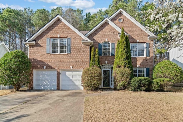 view of front of home featuring an attached garage, brick siding, and driveway