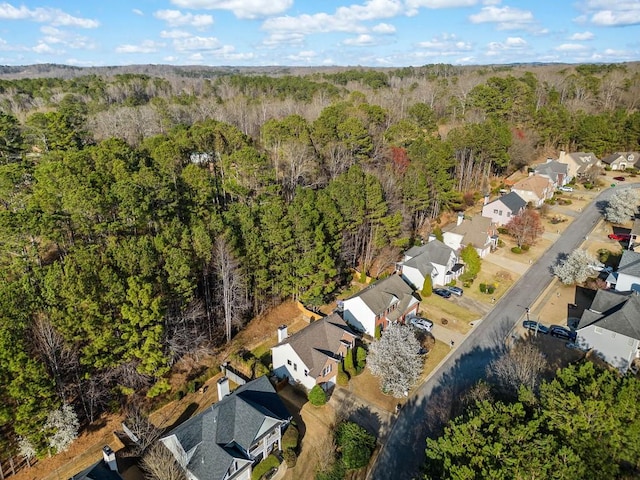 bird's eye view with a wooded view and a residential view