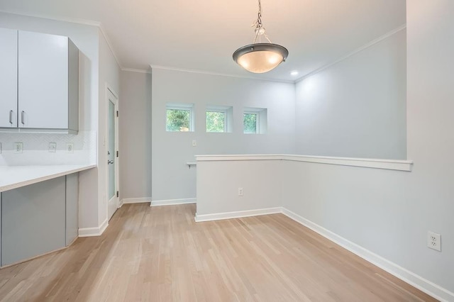 hall featuring crown molding and light hardwood / wood-style floors