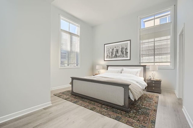 empty room with a wealth of natural light and light hardwood / wood-style flooring