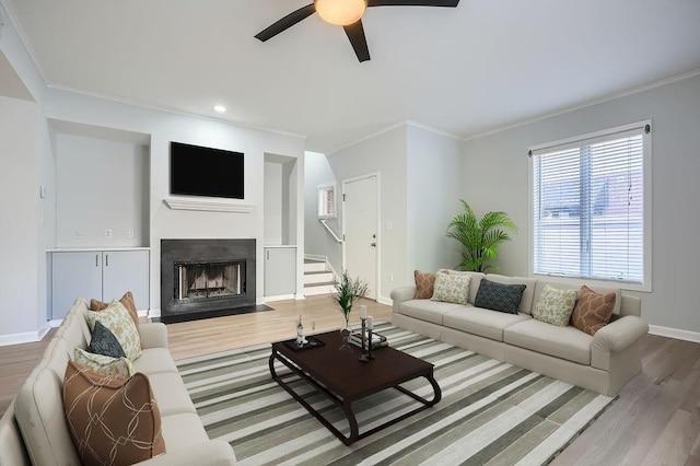 kitchen featuring hanging light fixtures, light hardwood / wood-style floors, a breakfast bar area, white cabinets, and appliances with stainless steel finishes