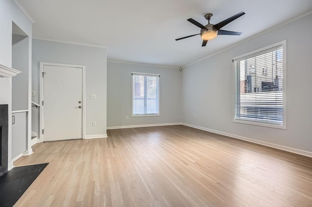 unfurnished living room featuring ceiling fan, light hardwood / wood-style floors, and crown molding