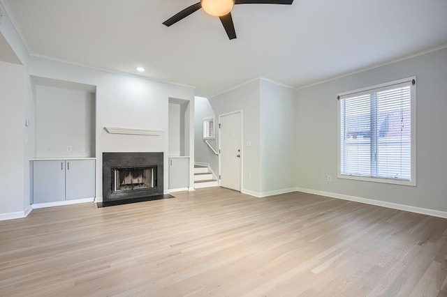 unfurnished living room featuring ceiling fan, light hardwood / wood-style floors, and ornamental molding