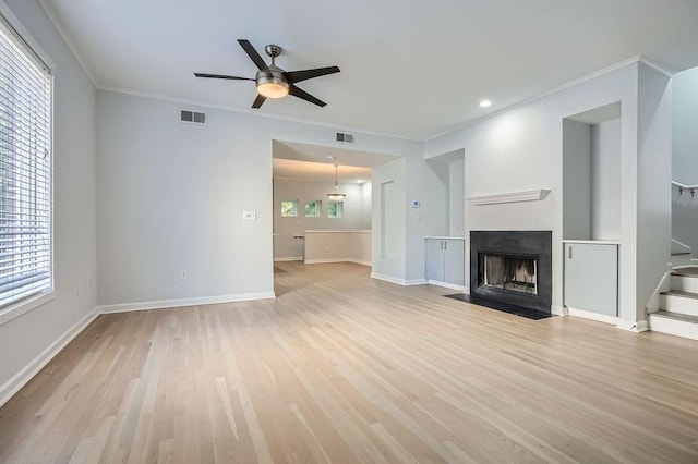 unfurnished dining area with light hardwood / wood-style floors and ornamental molding