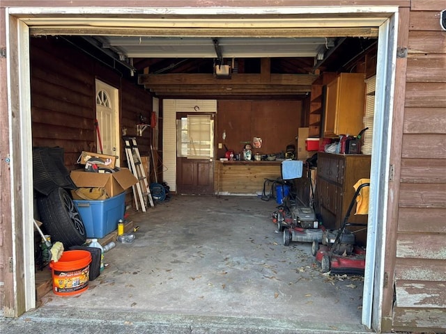 garage featuring wood walls