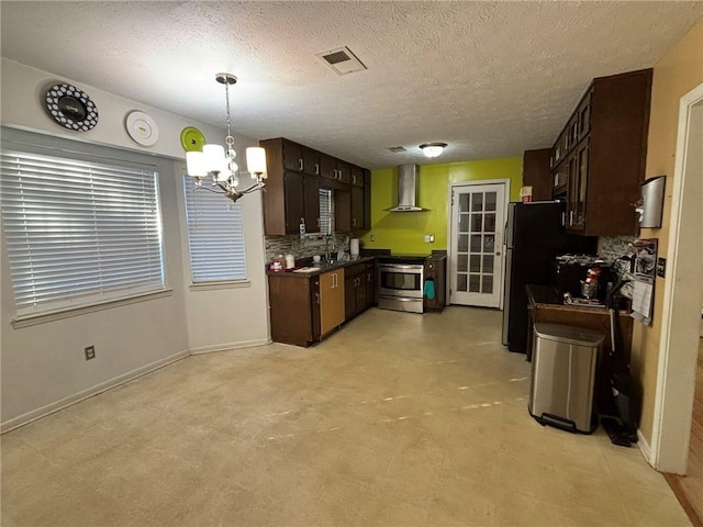 kitchen featuring tasteful backsplash, hanging light fixtures, dark brown cabinetry, stainless steel appliances, and wall chimney exhaust hood