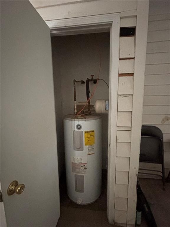 utility room featuring water heater