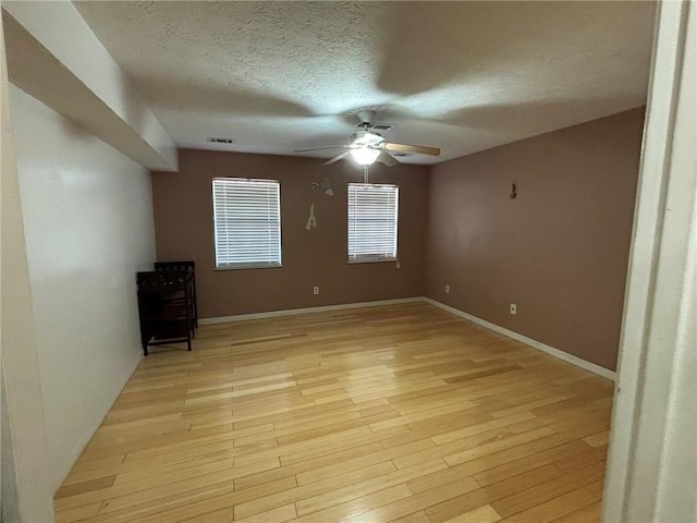 unfurnished bedroom featuring light hardwood / wood-style floors, a textured ceiling, and ceiling fan