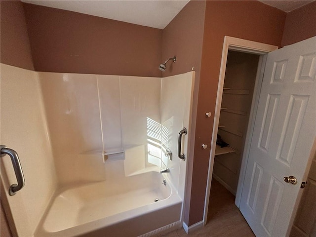 bathroom with shower / tub combination and hardwood / wood-style floors