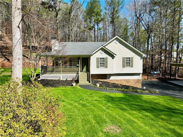 view of front of home with a chimney, a porch, a front yard, and a shingled roof