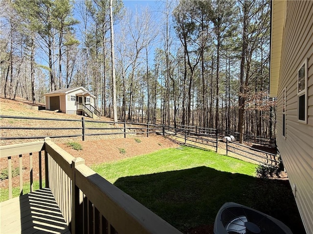 view of yard featuring central AC and fence