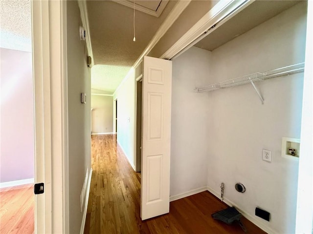 laundry area with wood finished floors, laundry area, attic access, washer hookup, and a textured ceiling