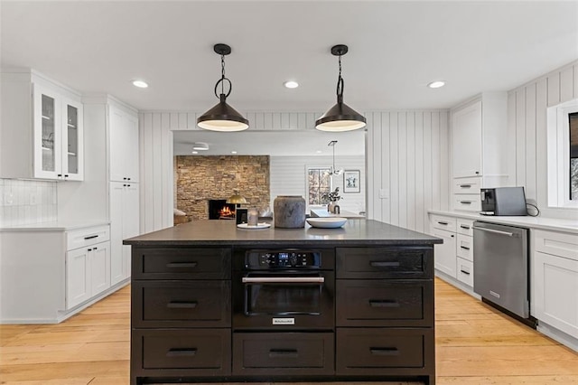 kitchen featuring dishwasher, light wood-type flooring, and white cabinetry